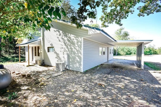 view of side of home featuring central AC and a patio area