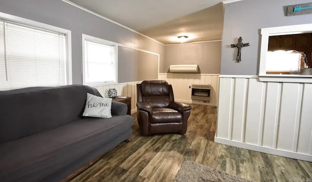 living room with heating unit, a wall unit AC, crown molding, and dark hardwood / wood-style flooring