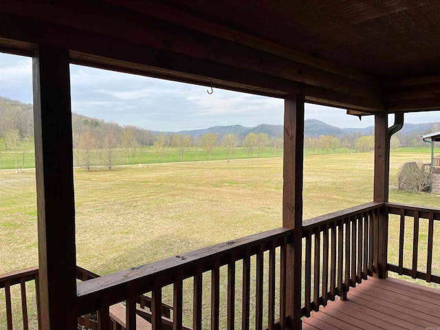 deck featuring a yard, a mountain view, and a rural view