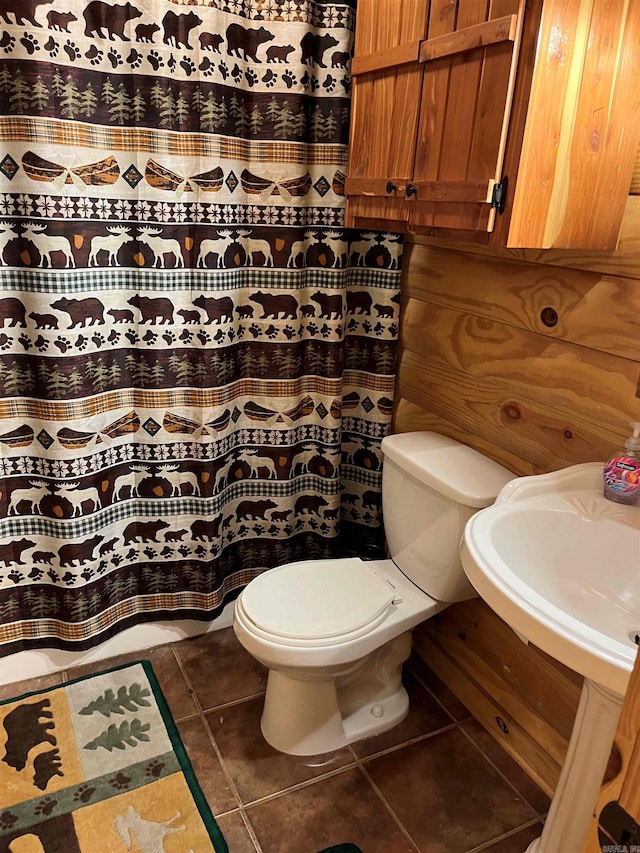 bathroom featuring toilet and tile floors