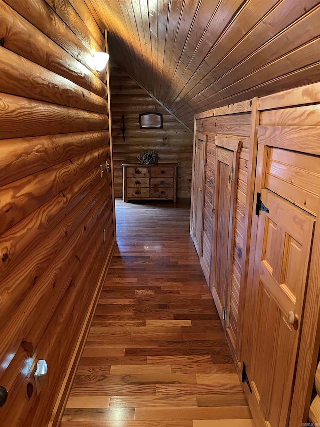 corridor with wood ceiling, lofted ceiling, dark wood-type flooring, and log walls