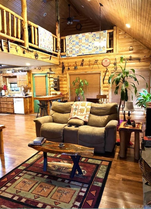 living room with ceiling fan, dark wood-type flooring, high vaulted ceiling, and wooden ceiling