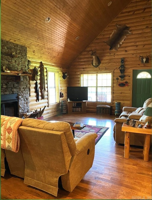 living room featuring a stone fireplace, wooden ceiling, dark wood-type flooring, and high vaulted ceiling