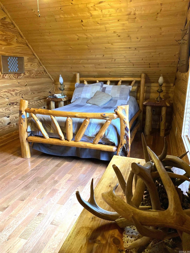 bedroom featuring log walls, vaulted ceiling, light hardwood / wood-style flooring, and wood ceiling