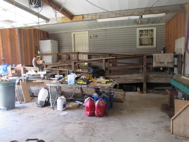 garage featuring a garage door opener and a workshop area