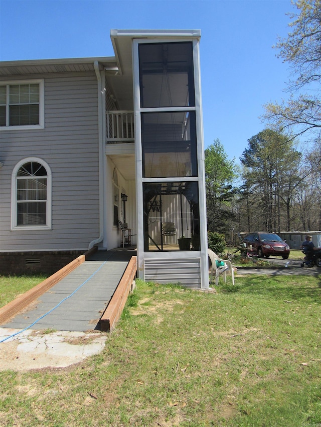 rear view of property featuring a lawn