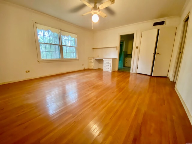 unfurnished bedroom featuring light hardwood / wood-style flooring, crown molding, and ceiling fan