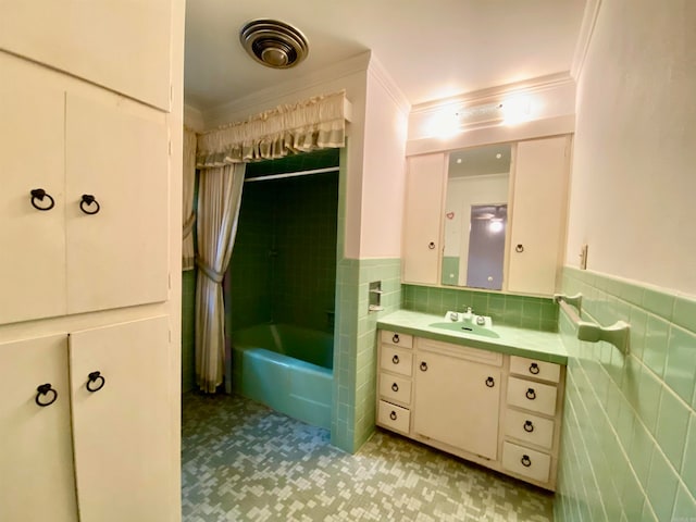 bathroom featuring vanity, tasteful backsplash, tiled shower / bath, tile walls, and tile floors