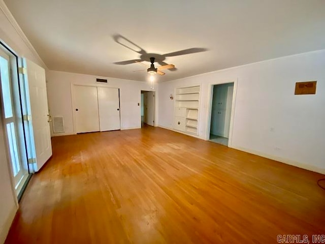 unfurnished bedroom featuring ceiling fan, light hardwood / wood-style floors, and multiple windows