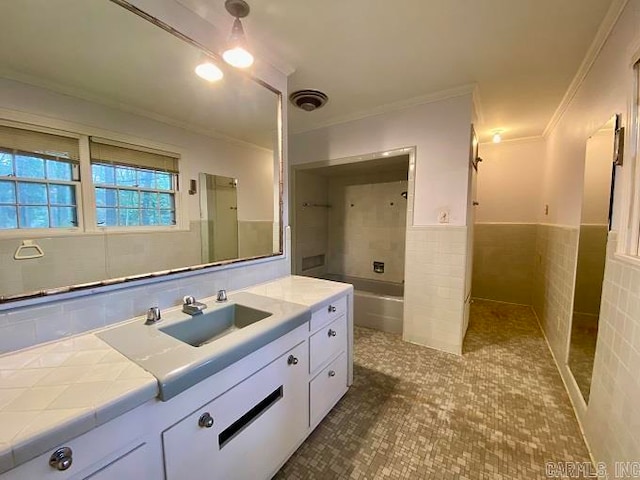 bathroom featuring vanity, shower / tub combination, tile walls, ornamental molding, and tile floors