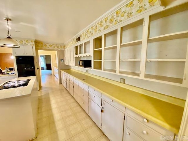 kitchen with white cabinets, decorative light fixtures, light tile floors, and gas cooktop