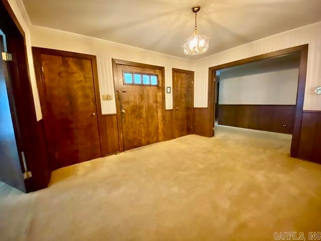 interior space featuring carpet and a chandelier