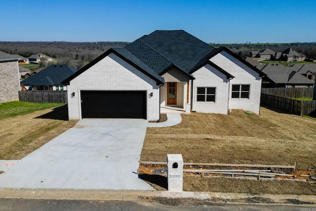 modern farmhouse with a front yard and a garage