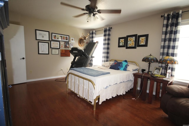 bedroom featuring dark wood-type flooring and multiple windows