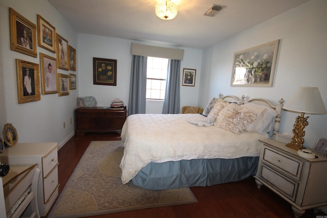 bedroom with dark wood-type flooring