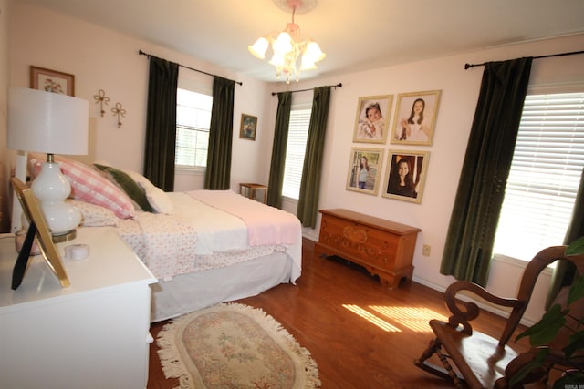 bedroom featuring a notable chandelier and dark hardwood / wood-style flooring