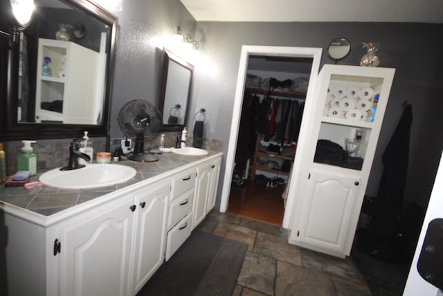 bathroom featuring tile flooring and double vanity