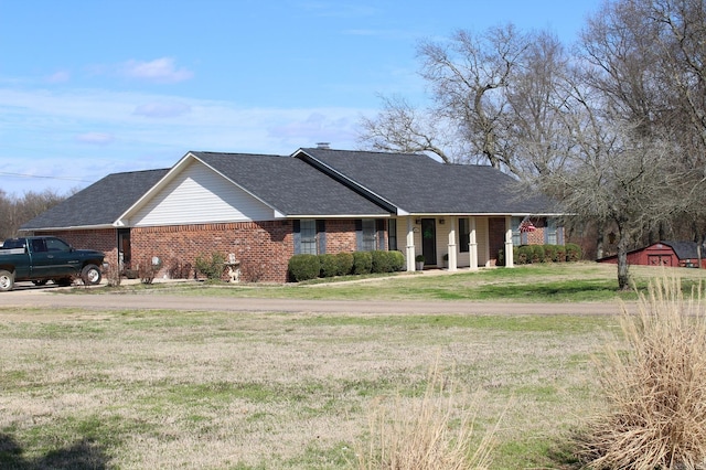 ranch-style house with a porch and a front lawn