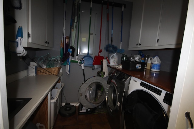 washroom featuring washing machine and dryer and cabinets