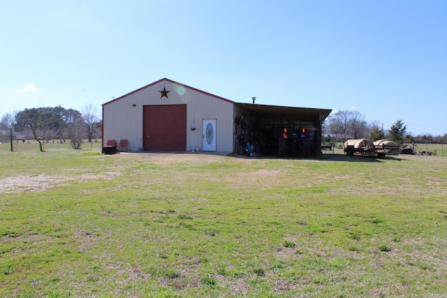 view of outdoor structure featuring a lawn and a garage