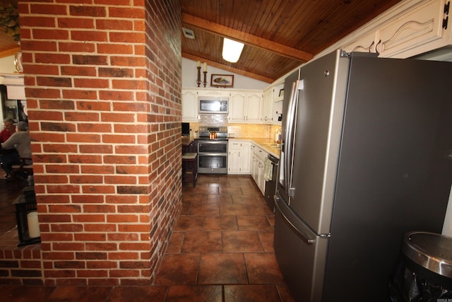 kitchen with lofted ceiling, stainless steel appliances, wooden ceiling, dark tile flooring, and tasteful backsplash