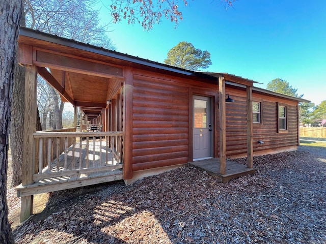 rear view of house featuring a wooden deck