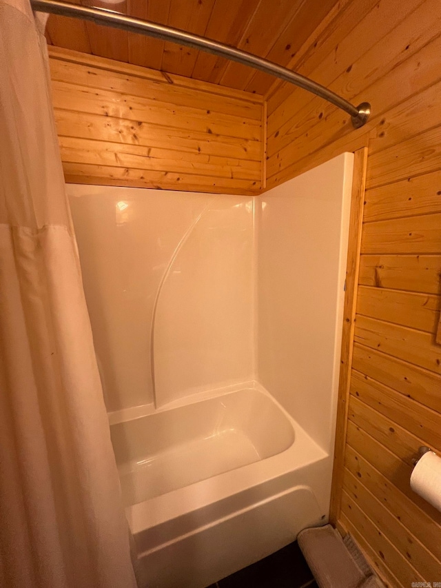 bathroom with shower / tub combo with curtain, wooden ceiling, and wood walls