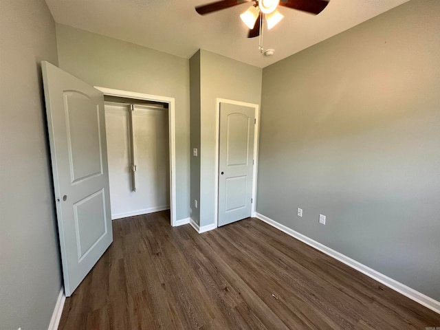 unfurnished bedroom featuring dark hardwood / wood-style flooring, a closet, and ceiling fan