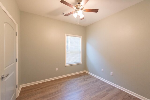 spare room featuring ceiling fan and hardwood / wood-style floors