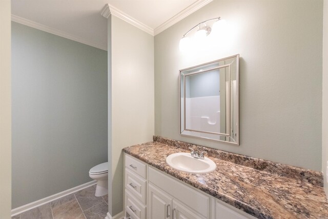 bathroom featuring vanity, toilet, tile floors, and ornamental molding