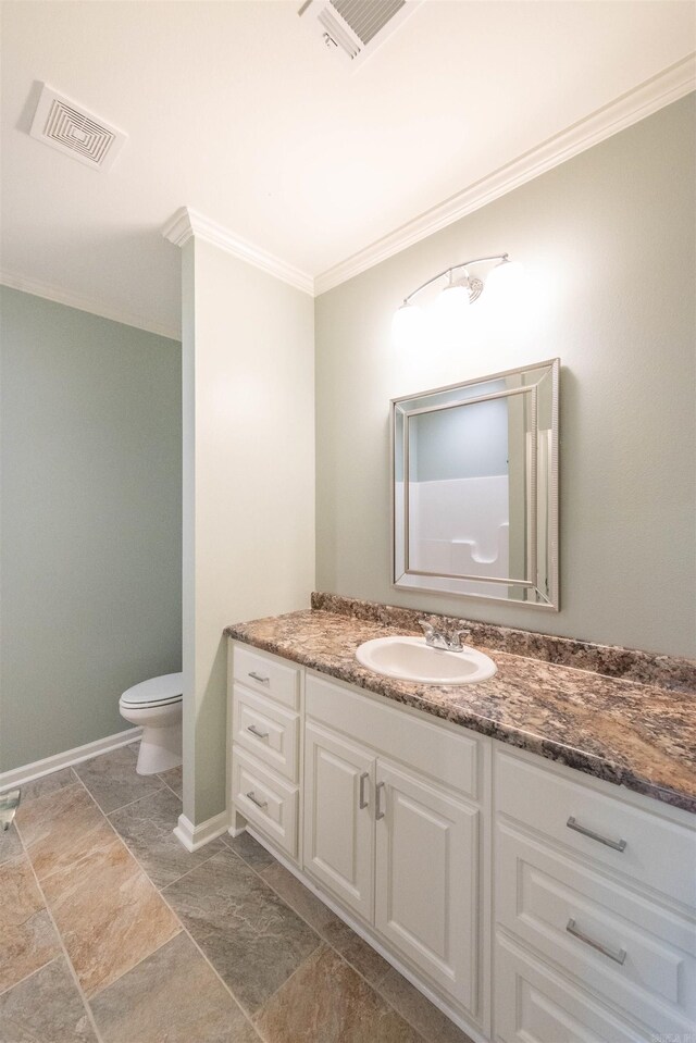 bathroom featuring tile flooring, crown molding, toilet, and vanity