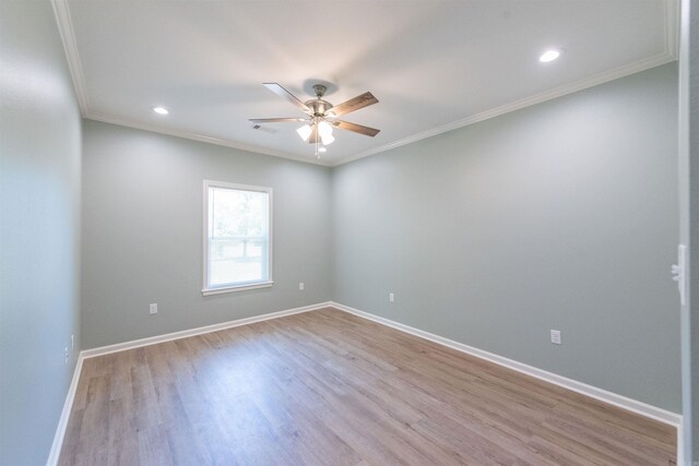 empty room featuring ceiling fan, crown molding, and hardwood / wood-style flooring