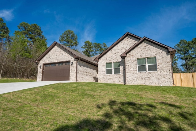 view of front of home with a front lawn and a garage