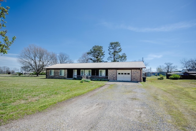 ranch-style house featuring a front lawn and a garage