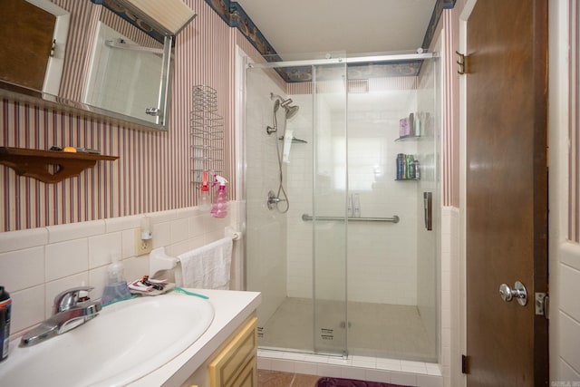 bathroom featuring tile walls, backsplash, an enclosed shower, and vanity with extensive cabinet space