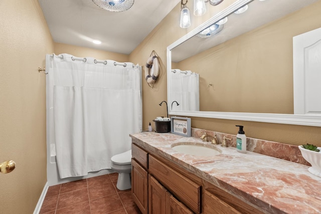 bathroom featuring tile floors, large vanity, and toilet