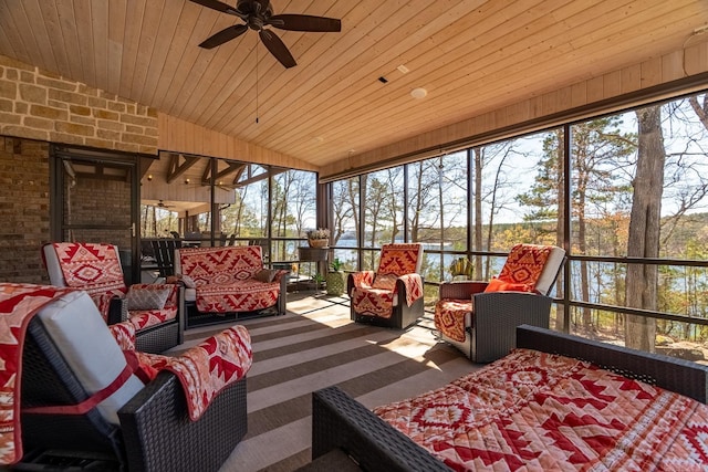 sunroom / solarium featuring ceiling fan, vaulted ceiling, wood ceiling, and plenty of natural light