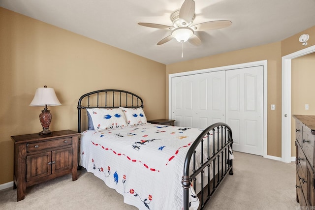 carpeted bedroom featuring a closet and ceiling fan