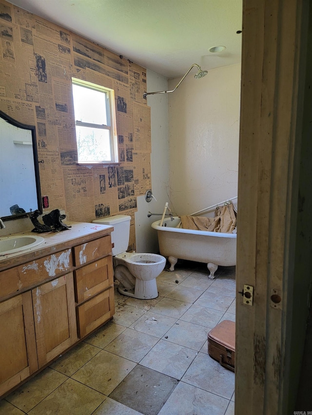 bathroom with a bidet, vanity, tile floors, and toilet