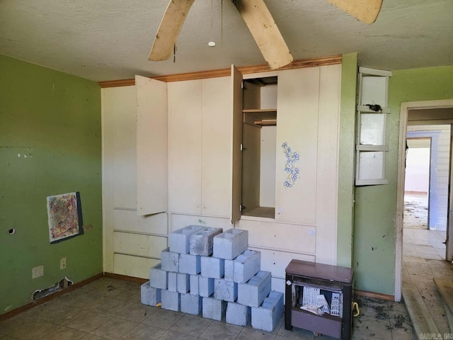 interior space with ceiling fan and a textured ceiling