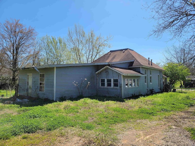 rear view of house with a lawn