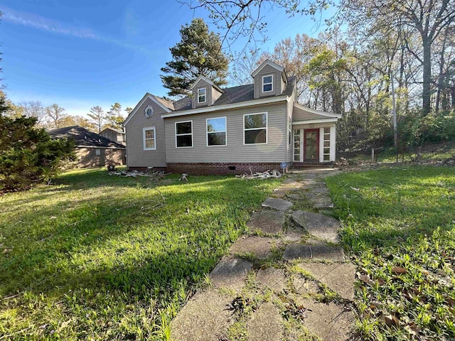 cape cod house with a front yard