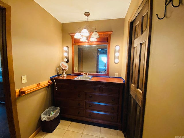 bathroom with tile floors, a notable chandelier, and vanity