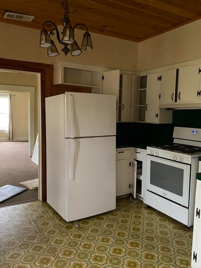 kitchen featuring white appliances, dark tile floors, a chandelier, wooden ceiling, and white cabinetry