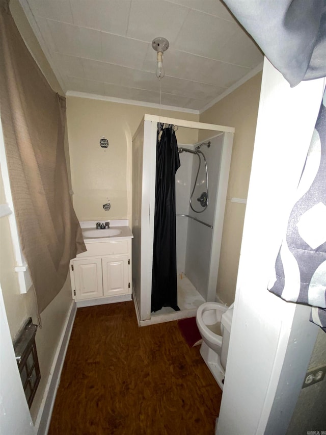 bathroom featuring toilet, hardwood / wood-style floors, ornamental molding, and walk in shower