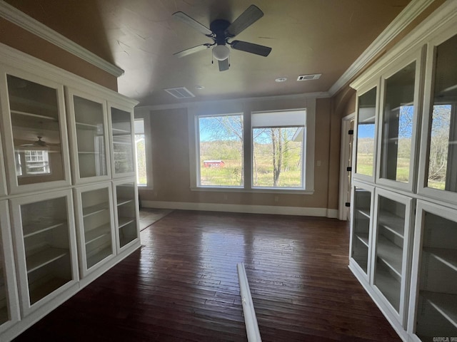 interior space with ceiling fan, dark hardwood / wood-style flooring, and ornamental molding