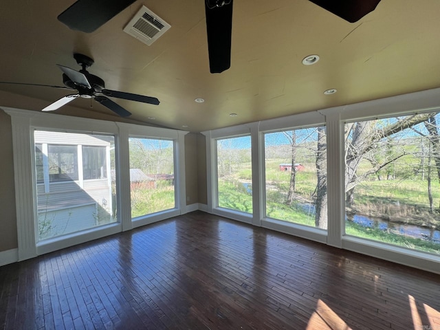 unfurnished sunroom with ceiling fan