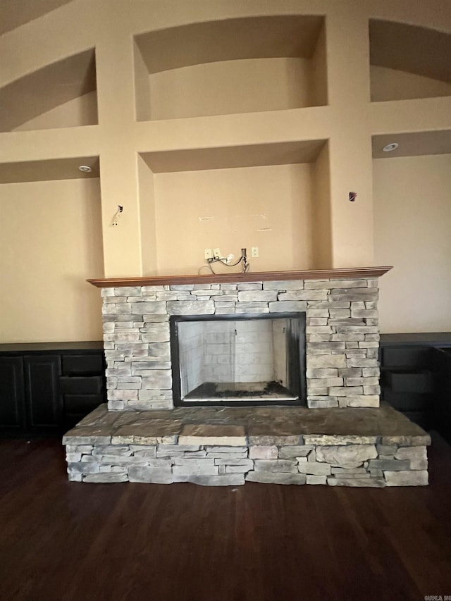 details featuring a fireplace and dark hardwood / wood-style floors