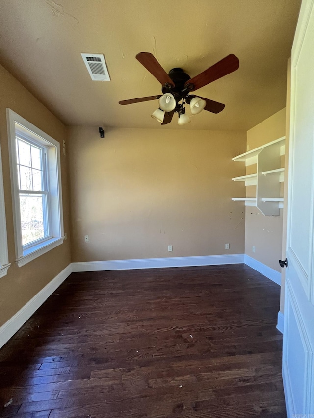 spare room featuring dark hardwood / wood-style flooring and ceiling fan