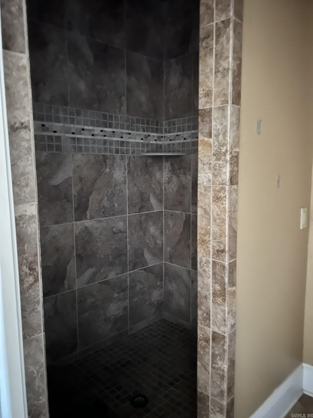 bathroom with tiled shower